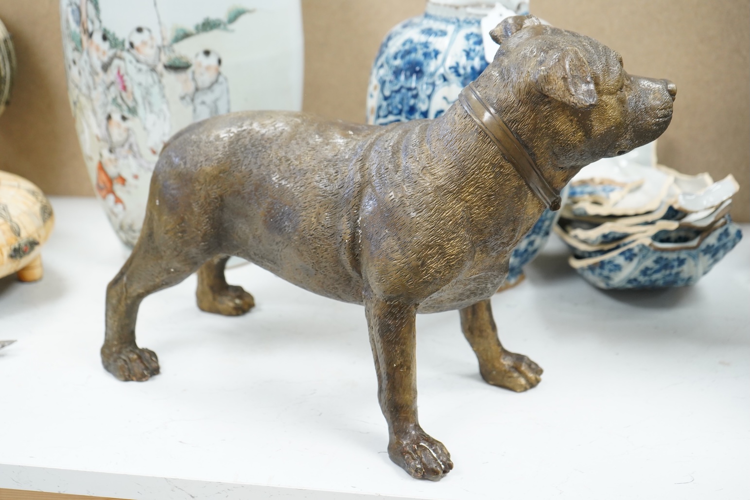 A large solid cast bronze model of a Staffordshire bull terrier, Italian, mid 20th century, signed, 45cm wide